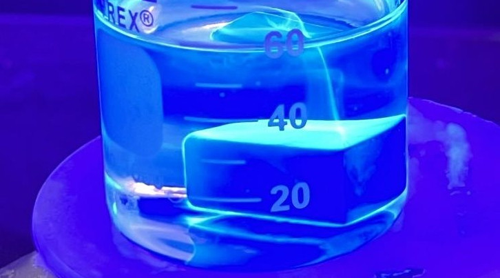 Material testing setup illuminated under ultraviolet light