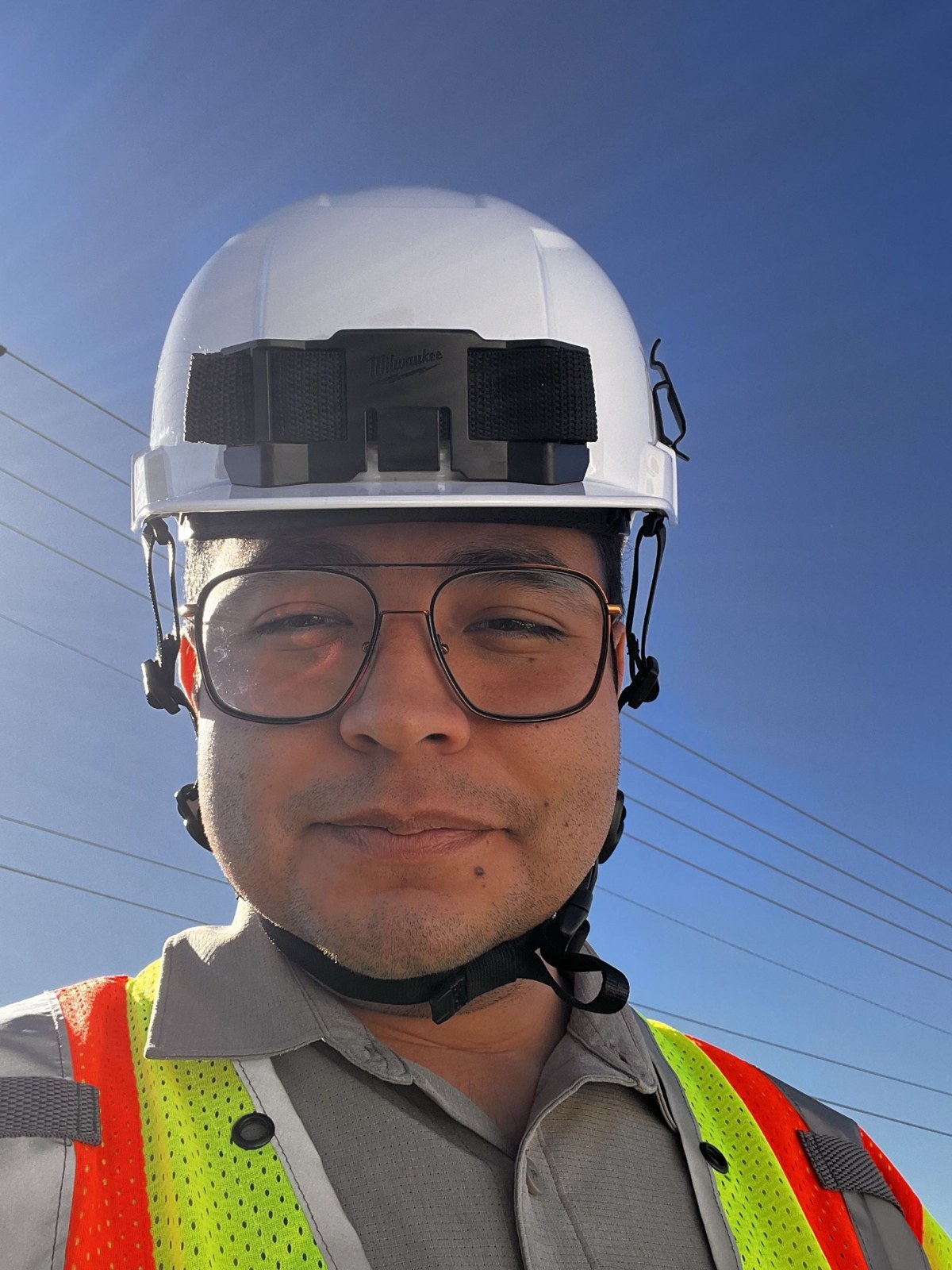David Vidrio wearing engineering field safety gear and a hard hat