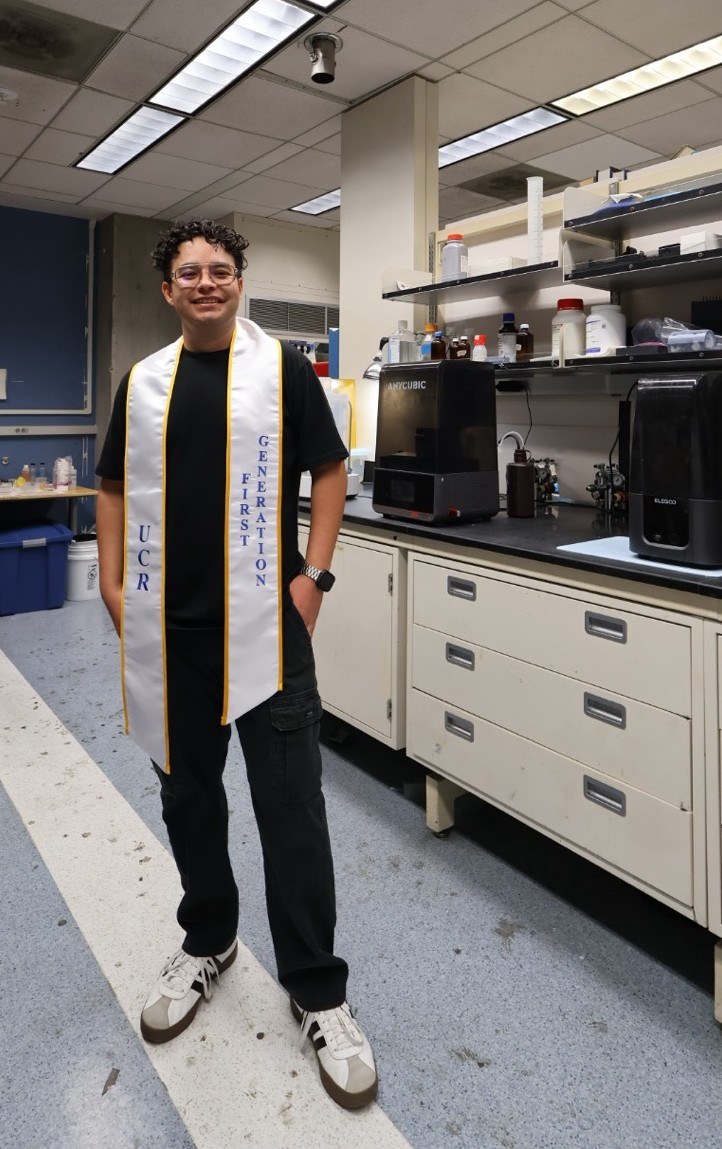 David in a research laboratory wearing a UCR First Generation stole